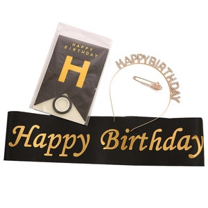 Birthday party decoration set with black sash, gold tiara, pin, and banner kit