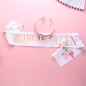 Detail of white Birthday Queen satin sash with gold lettering and crystal crown