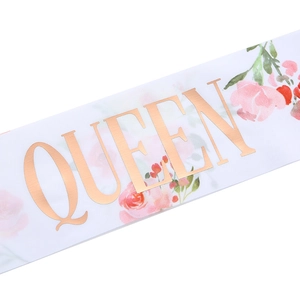 White satin Birthday Queen sash with rose gold foil lettering and pink floral patterns