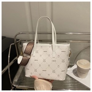 Detail of white leather tote featuring LNBOE cartoon print and woven jacquard strap