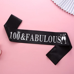 Detail of black 100 & Fabulous birthday sash with silver lettering on pink background