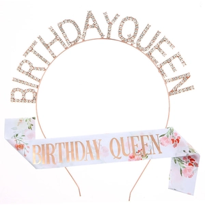Close-up of Rose Gold Birthday Queen rhinestone headband and white floral satin sash set