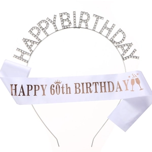 Detail of 60th birthday set with rhinestone tiara and rose gold satin sash decoration