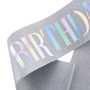 Detail of silver glitter birthday sash featuring holographic iridescent lettering