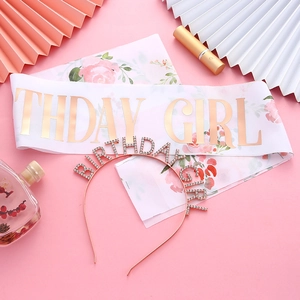 Close-up of Birthday Girl white satin sash with gold print and rose gold tiara set