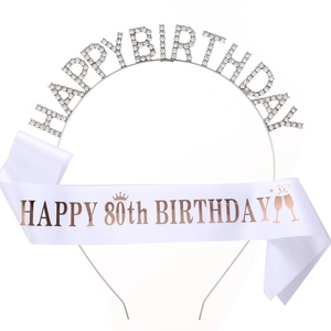 Close-up of sparkling rhinestone birthday tiara and 80th birthday satin sash set