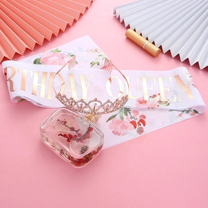 Close-up of rose gold rhinestone crown and Birthday Queen satin sash set for party