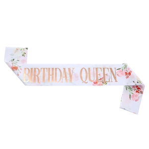 White satin Birthday Queen sash with pink floral patterns and elegant gold foil lettering
