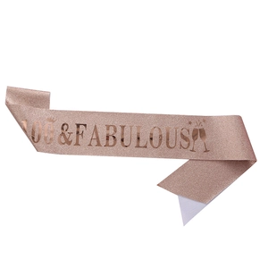 Detail of rose gold 100 and FABULOUS glitter sash with champagne glass motif for birthday