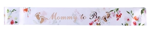 Detail of white satin Mommy to Be sash with floral patterns and gold foil lettering