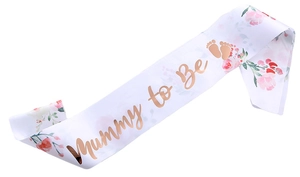 Close-up of Mummy to Be white satin sash with rose gold lettering and pink floral print