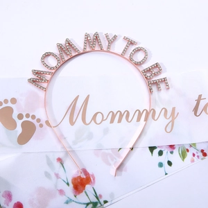 Detail of Mommy to Be rose gold rhinestone headband and white satin sash for baby showers