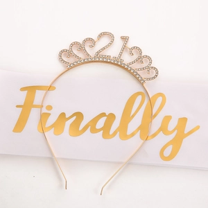 Sparkling gold 21st birthday crown with rhinestones shown on elegant white satin sash