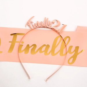 Close-up of rose gold metal headband and pink satin sash for 21st birthday celebrations
