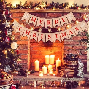 Detail of burlap Merry Christmas bunting banner with red letters and snowflake patterns