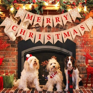 Merry Christmas burlap banner hanging in a cozy room with dogs and fireplace