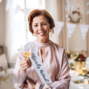 Glittering silver sash with black Officially Retired text for party celebration