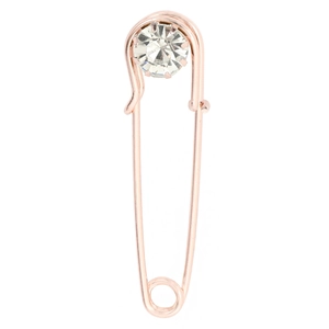 Close-up of rose gold safety pin brooch with a large faceted round crystal stone