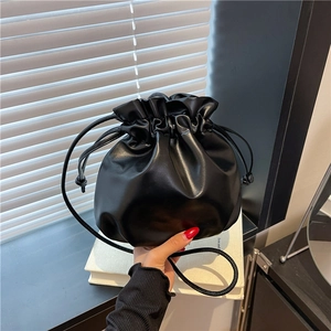 Minimalist black drawstring bucket bag in premium PU leather with soft pleats