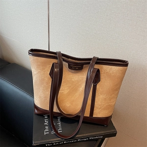 Retro khaki tote bag with dark brown leather trim and shoulder straps for daily commute