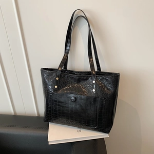 Retro black crocodile embossed large tote bag with top handles on white book