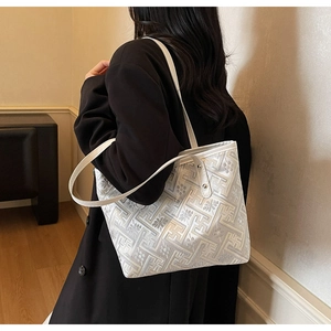 Detail of white geometric jacquard tote bag with leather strap and vintage floral texture