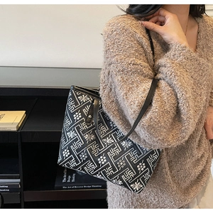 Ethnic pattern tote bag detail showing black and white geometric print and shoulder strap