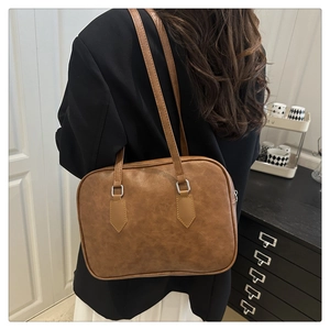 Brown leather Boston bag details with silver square metal hardware and premium stitching
