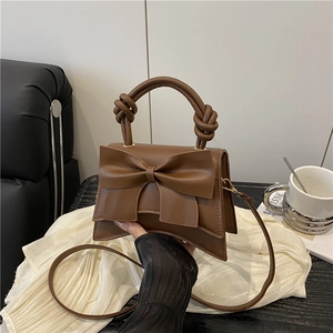 Brown bow accent crossbody bag with knotted handle for women in autumn 2025 fashion style
