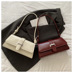 Detail view of the silver metal lock and stylish knotted strap on the leather hobo bag