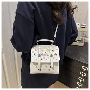 Detail of white PU leather crossbody bag with Tidal Dryness print and top handle