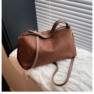 Detail of caramel suede hobo bag with gold hardware and smooth metallic zipper