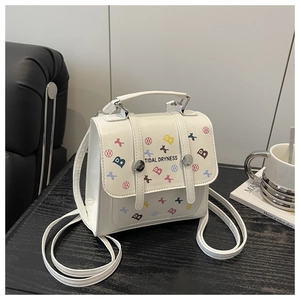 Close-up of white rectangular bag with colorful geometric patterns and B letter prints