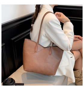 Brown lychee leather tote bag worn with white blazer for a stylish minimalist office look