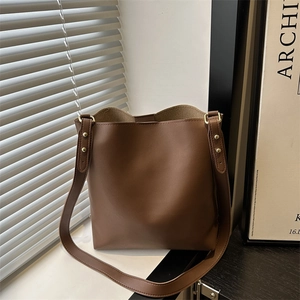 Minimalist brown PU leather tote bag with gold rivet details and long shoulder strap