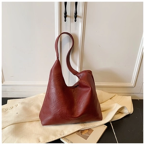 Detailed view of dark red vintage faux leather tote bag with soft pleated texture