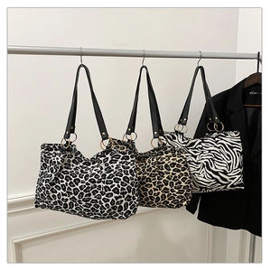 Three tote bags featuring leopard and zebra patterns with black faux leather straps