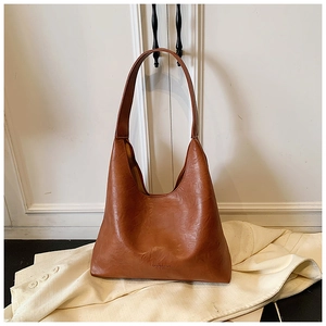 Close-up of caramel retro tote bag material with FASHION & BAGS LEATHER embossing