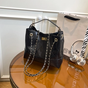 Classic black quilted leather tote bag with gold chain strap and metal swivel lock closure
