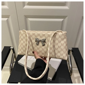 Chic cream-colored printed tote bag with silver bow buckle and long shoulder strap