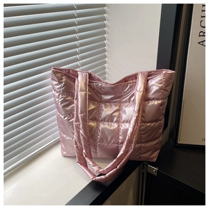 Detail shot of pink shiny quilted tote bag made of high-gloss padded space cotton fabric