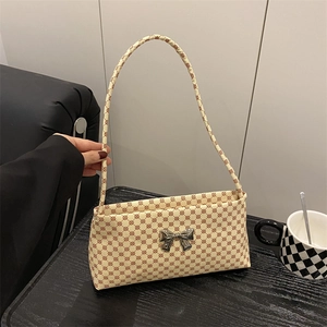 Vintage patterned tote bag with beige base and reddish-brown geometric circles and bow buckle