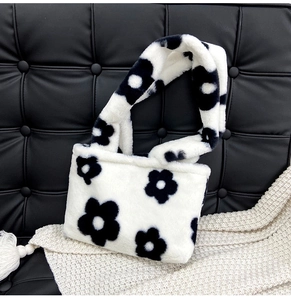 Détail du cabas en peluche avec motif de fleurs noires sur texture de fausse fourrure