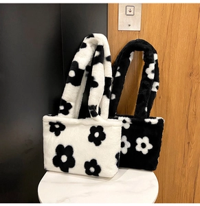 Détail de sacs cabas en peluche douce avec de grands motifs floraux noirs et blancs