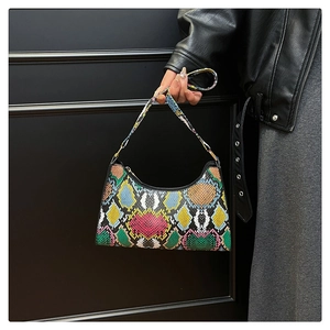 Detail of colorful snakeskin texture and crescent shape on a chic fashion handbag