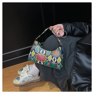 Close-up of vibrant colorful snakeskin pattern on a stylish hobo style handbag
