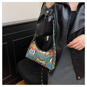 Close-up of vibrant faux python skin pattern on a trendy fashion crossbody hobo bag