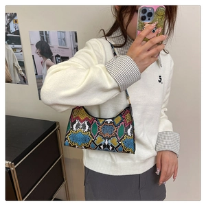 Close-up of colorful faux snake skin texture and geometric pattern on the shoulder bag