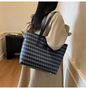 Detail of printed large capacity tote bag featuring geometric patterns and leather straps