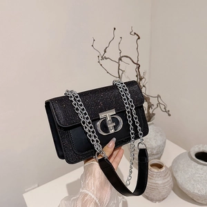 Chic black sequin crossbody bag with silver chain strap and metal lock closure